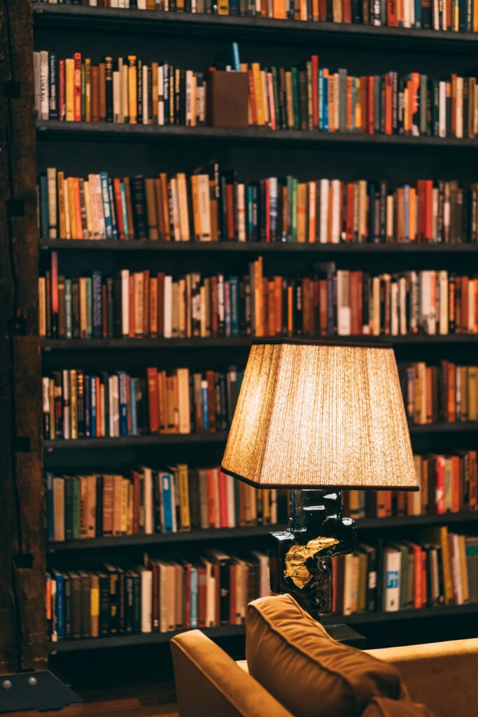Cozy home library with bookshelf and warm reading lamp